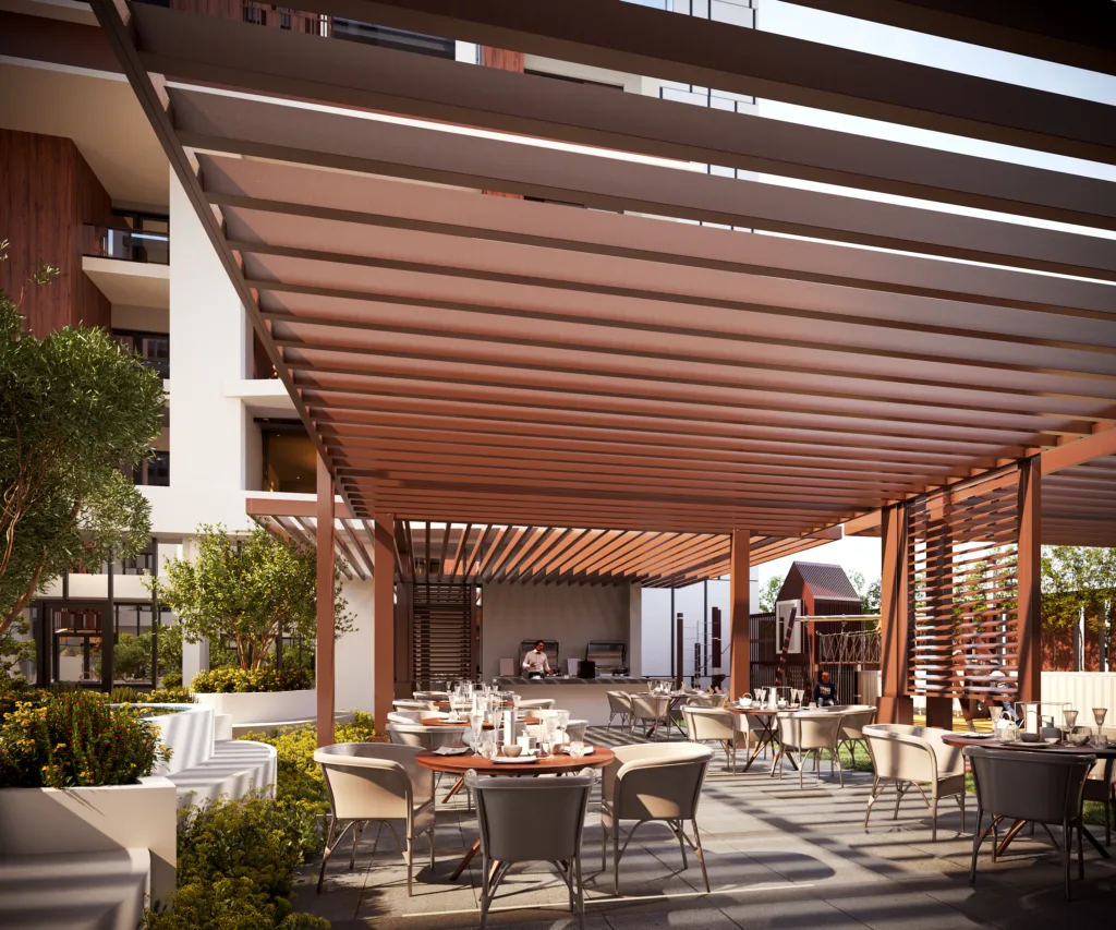 The Dining Pavilion at the barbecue area in the foreground of the image blends into the juice bar, which is connected to the social house, as seen in the center frame of the image.